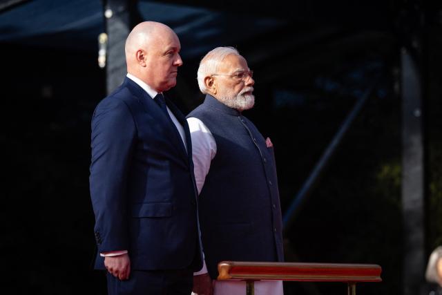 India's Prime Minister Narendra Modi (R) is welcomed by New Zealand Prime Minister Christopher Luxon (L) during a ceremony at Government House in Auckland on July 11, 2026. (Photo by Dean Purcell / POOL / AFP)
