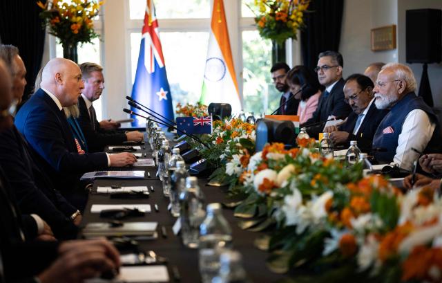 India's Prime Minister Narendra Modi (centre-R) speaks with New Zealand Prime Minister Christopher Luxon (centre-L) during a bilateral meeting at Government House in Auckland on July 11, 2026. (Photo by Dean Purcell / POOL / AFP)