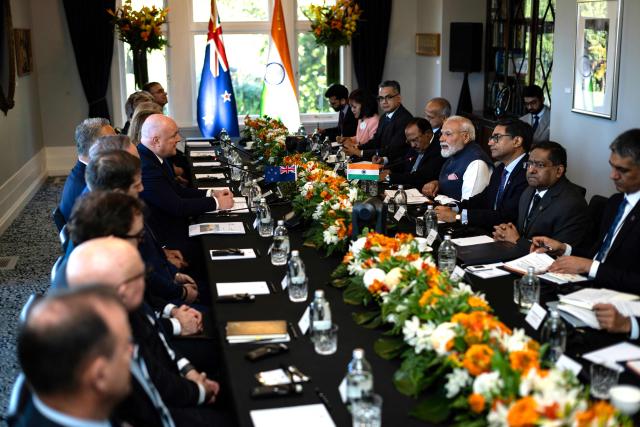 India's Prime Minister Narendra Modi (centre-R) speaks with New Zealand Prime Minister Christopher Luxon (centre-L) during a bilateral meeting at Government House in Auckland on July 11, 2026. (Photo by Dean Purcell / POOL / AFP)