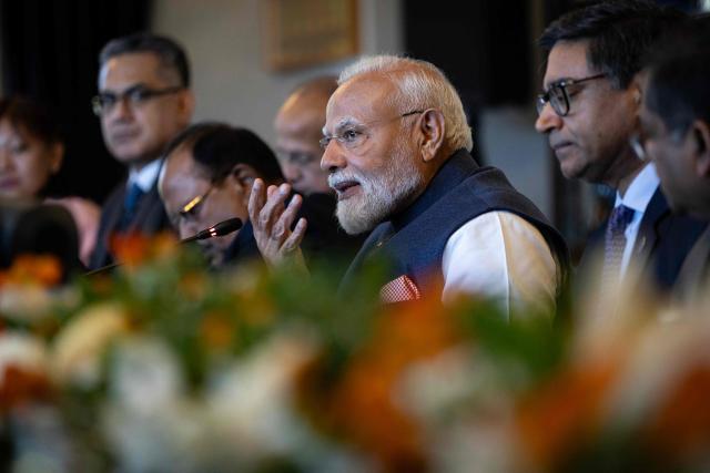 India's Prime Minister Narendra Modi (C) speaks with New Zealand Prime Minister Christopher Luxon (not pictured) during a bilateral meeting at Government House in Auckland on July 11, 2026. (Photo by Dean Purcell / POOL / AFP)