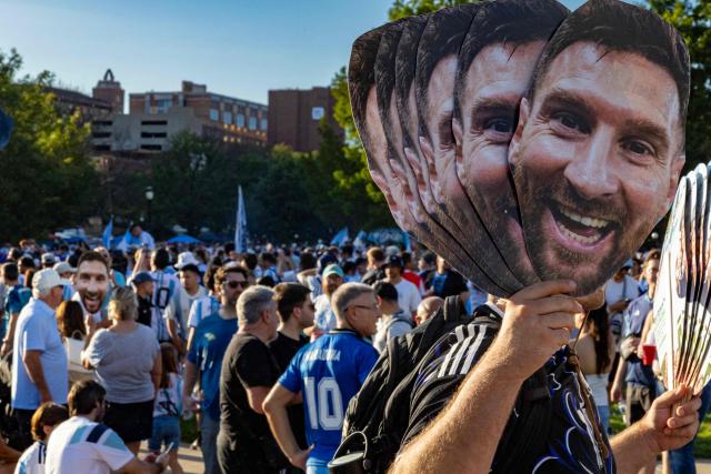 An Argentine fan holds cardboard cutouts depicting Argentina's forward Lionel Messi in a gathering in Kansas City on July 10, 2026, on the eve of the 2026 World Cup football match between Argentina and Switzerland. (Photo by Odd Andersen / AFP)