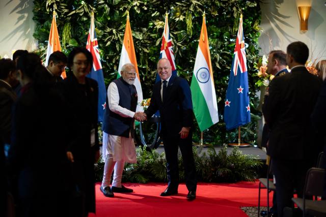India's Prime Minister Narendra Modi (L) and New Zealand Prime Minister Christopher Luxon (R) shake hands during an Exchanging of Arrangements at Government House in Auckland on July 11, 2026. (Photo by Dean Purcell / POOL / AFP)