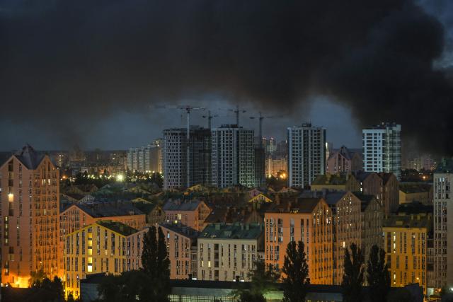 This photo shows smoke rising during Russian missile strikes on the Ukrainian capital of Kyiv early on July 11, 2026, amid the Russian invasion in Ukraine. Ukraine said Russian missile strikes on Kyiv wounded six people, as Moscow escalates attacks on the Ukrainian capital. AFP journalists in Kyiv heard two series of explosions in the early hours of Saturday, with an air alert siren sounding minutes after the first blast. (Photo by Evgen KOTENKO / AFP)
