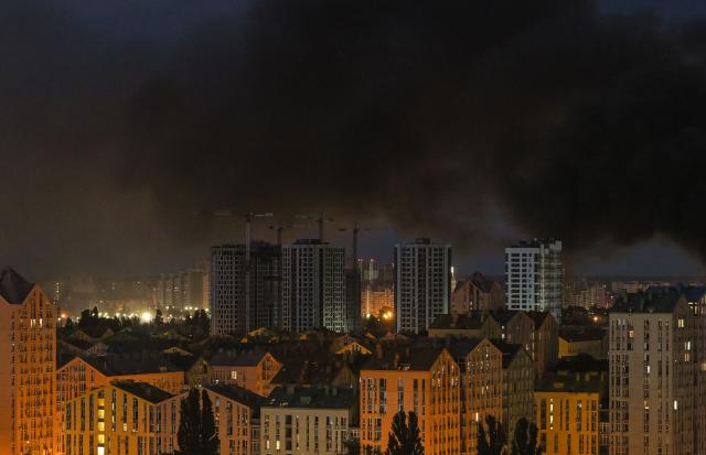 This photo shows smoke rising during Russian missile strikes on the Ukrainian capital of Kyiv early on July 11, 2026, amid the Russian invasion in Ukraine. Ukraine said Russian missile strikes on Kyiv wounded six people, as Moscow escalates attacks on the Ukrainian capital. AFP journalists in Kyiv heard two series of explosions in the early hours of Saturday, with an air alert siren sounding minutes after the first blast. (Photo by Evgen KOTENKO / AFP)