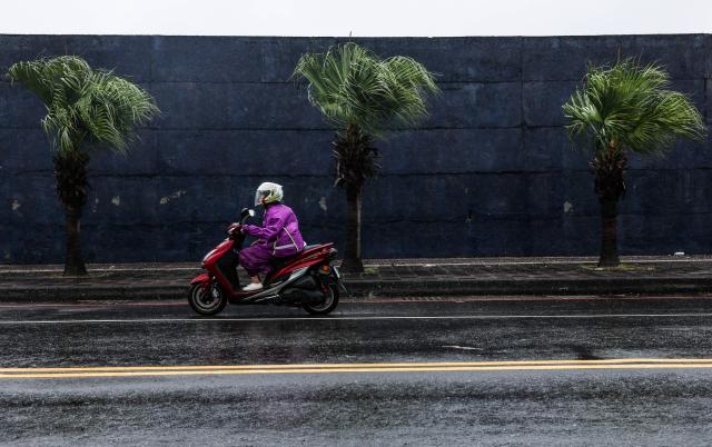 CORRECTION / A person rides a scooter in the rain amid weather patterns from Typhoon Bavi in Keelung on July 11, 2026. (Photo by I-Hwa Cheng / AFP) / “The erroneous mention[s] appearing in the metadata of this photo by I-Hwa Cheng has been modified in AFP systems in the following manner: [July 11] instead of [July 10]. Please immediately remove the erroneous mention[s] from all your online services and delete it (them) from your servers. If you have been authorized by AFP to distribute it (them) to third parties, please ensure that the same actions are carried out by them. Failure to promptly comply with these instructions will entail liability on your part for any continued or post notification usage. Therefore we thank you very much for all your attention and prompt action. We are sorry for the inconvenience this notification may cause and remain at your disposal for any further information you may require.”