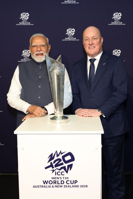 India's Prime Minister Narendra Modi (L) and New Zealand's Prime Minister Christopher Luxon pose with the T20 Cricket World Cup trophy at the Viaduct Events Centre in Auckland on July 11, 2026. (Photo by Michael Bradley / POOL / AFP)