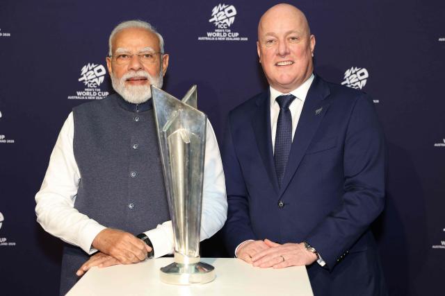 India's Prime Minister Narendra Modi (L) and New Zealand's Prime Minister Christopher Luxon pose with the T20 Cricket World Cup trophy at the Viaduct Events Centre in Auckland on July 11, 2026. (Photo by Michael Bradley / POOL / AFP)