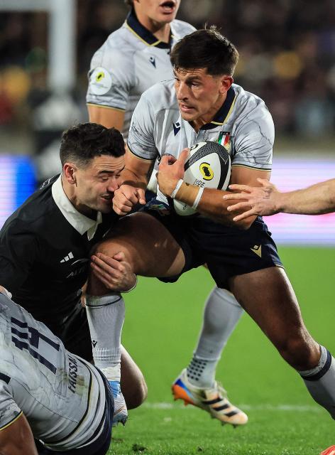 Tommaso Allan of Italy is tackled by Will Jordan of New Zealand during the Nations Championship match between the New Zealand All Blacks and Italy at HNRY Stadium in Wellington on July 11, 2026. (Photo by Grant Down / AFP)