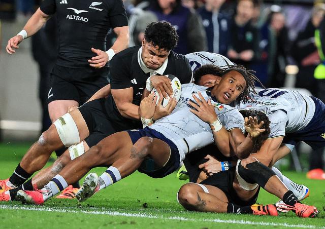 Malik Faissal (centre R) of Italy competes for the ball with Wallace Sititi (centre L) of New Zealand during the rugby union Nations Championship match between the New Zealand All Blacks and Italy at HNRY Stadium in Wellington on July 11, 2026. (Photo by Grant Down / AFP)