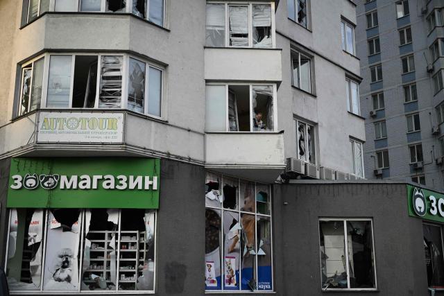 A resident clears shattered glass in a multistorey residential building, damaged following a Russian missile strike on the Ukrainian capital of Kyiv early on July 11, 2026, amid the Russian invasion in Ukraine. Ukraine said Russian missile strikes on Kyiv wounded six people, as Moscow escalates attacks on the Ukrainian capital. AFP journalists in Kyiv heard two series of explosions in the early hours of July 11, with an air alert siren sounding minutes after the first blast. (Photo by Genya SAVILOV / AFP)