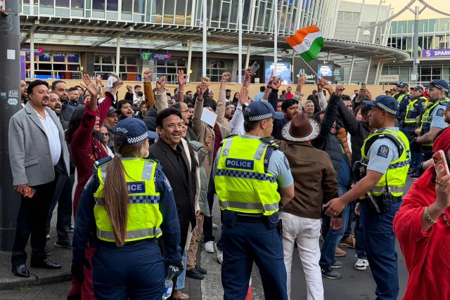 CORRECTION / Supporters of India's Prime Minister Narendra Modi are held back by police against an anti-Modi protest rally outside a venue where Modi is appearing in Auckland on July 11, 2026. (Photo by Ben STRANG / AFP) / “The erroneous mention[s] appearing in the metadata of this photo by Ben STRANG has been modified in AFP systems in the following manner: AFP as source instead of POOL. Please immediately remove the erroneous mention[s] from all your online services and delete it (them) from your servers. If you have been authorized by AFP to distribute it (them) to third parties, please ensure that the same actions are carried out by them. Failure to promptly comply with these instructions will entail liability on your part for any continued or post notification usage. Therefore we thank you very much for all your attention and prompt action. We are sorry for the inconvenience this notification may cause and remain at your disposal for any further information you may require.”