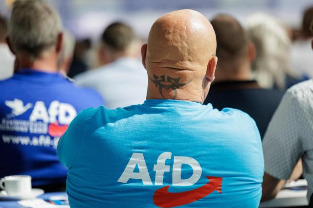 A delegate with a tattoo on his neck attends the state party convention of the far-right Alternative for Germany party (AfD) in Magdeburg, eastern Germany on July 11, 2026. At its party conference, the AfD presented its 100-day programme for the period following the state election scheduled for September 6, 2026. (Photo by Jens SCHLÜTER / AFP)