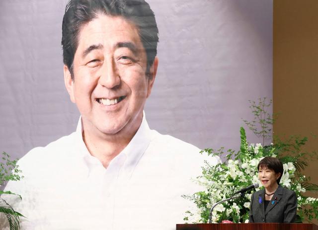 Japan's Prime Minister Sanae Takaichi (bottom R) delivers a speech during a memorial service for former prime minister Shinzo Abe, four years after his murder, in Tokyo on July 11, 2026. (Photo by JIJI PRESS / AFP) / Japan OUT