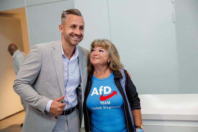 Ulrich Siegmund, the far-right Alternative for Germany party's top candidate for the regional elections in Saxony-Anhalt, poses for a photo with a delegate during the state party convention of the far-right Alternative for Germany party (AfD) in Magdeburg, eastern Germany on July 11, 2026. At its party conference, the AfD presented its 100-day programme for the period following the state election scheduled for September 6, 2026. (Photo by Jens SCHLÜTER / AFP)