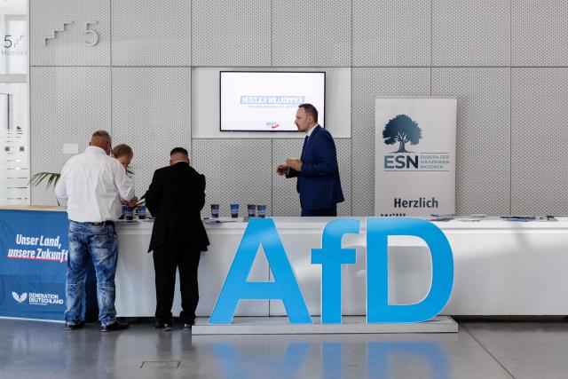 Delegates are pictured during the state party convention of the far-right Alternative for Germany party (AfD) in Magdeburg, eastern Germany on July 11, 2026. At its party conference, the AfD presented its 100-day programme for the period following the state election scheduled for September 6, 2026. (Photo by Jens SCHLÜTER / AFP)