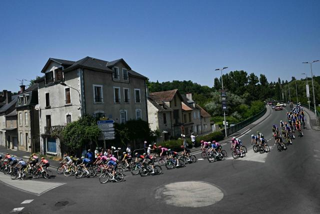The pack of riders (peloton) cycles during the 8th stage of the 113th edition of the Tour de France cycling race, 180,4 km between Perigueux and Bergerac in southwestern France, on July 11, 2026. (Photo by Loic VENANCE / AFP)