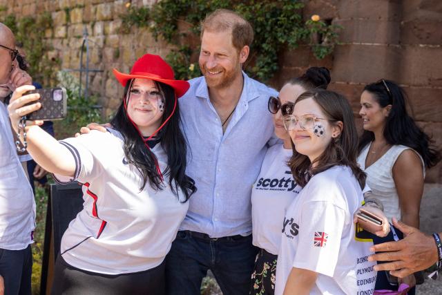 Britain's Prince Harry, Duke of Sussex, poses for a selfie photogrpah with well-wishers as he attends 'Scotty's Summer Festival' at Maxstoke Castle near Birmingham, central England on July 11, 2026. (Photo by Heathcliff O'MALLEY / POOL / AFP)
