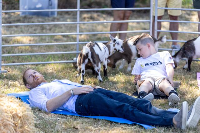 Britain's Prince Harry, Duke of Sussex, reacts as he takes part in a 'Goat Yoga' class as he attends 'Scotty's Summer Festival' at Maxstoke Castle near Birmingham, central England on July 11, 2026. (Photo by Heathcliff O'MALLEY / POOL / AFP)