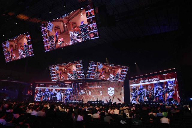 Spectators look at teams 100 Thieves and NongShim RedForce playing Valorant during the 2026 Esports World Cup at the Paris Expo Porte de Versailles venue in Paris, on July 11, 2026. (Photo by Thomas SAMSON / AFP)