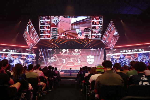 Spectators look at teams 100 Thieves and NongShim RedForce playing Valorant during the 2026 Esports World Cup at the Paris Expo Porte de Versailles venue in Paris, on July 11, 2026. (Photo by Thomas SAMSON / AFP)