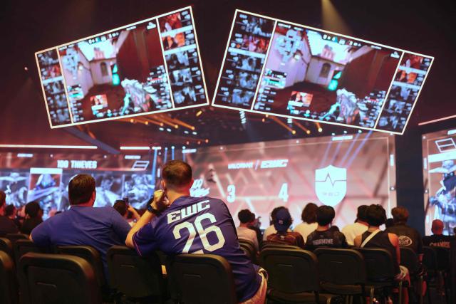 Spectators look at teams 100 Thieves and NongShim RedForce playing Valorant during the 2026 Esports World Cup at the Paris Expo Porte de Versailles venue in Paris, on July 11, 2026. (Photo by Thomas SAMSON / AFP)