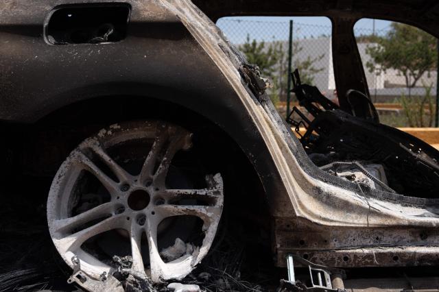 A picture taken on July 11, 2026 shows the burned-out car of one of the victims of a wildfire that killed 12, in Mojacar, near Los Gallardos, in Almeria Province. Firefighters aided by better weather on July 11 gained the upper hand on one of Spain's deadliest wildfires, that killed at least 12 people and burned about 6,600 hectares (16,300 acres) since July 9. (Photo by JORGE GUERRERO / AFP)