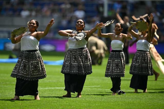 People perform on the pitch ahead of the Rugby Union Nations Championship match between Fiji and England at Hill Dickinson Stadium in Liverpool on July 11, 2026. (Photo by Oli SCARFF / AFP)