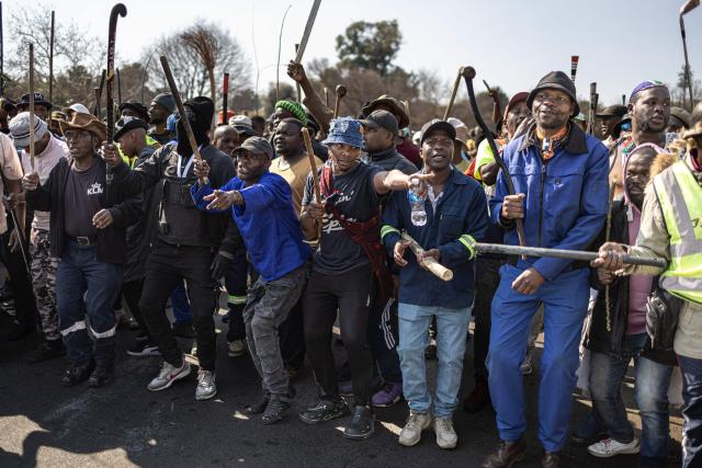 Protesters gesture during an anti-migration demonstration in Norwood on July 11, 2026. Protests that began with groups like March and March have since spread to ordinary residents taking to the streets, as anti-migrant sentiment continues to spread across South Africa. (Photo by EMMANUEL CROSET / AFP)