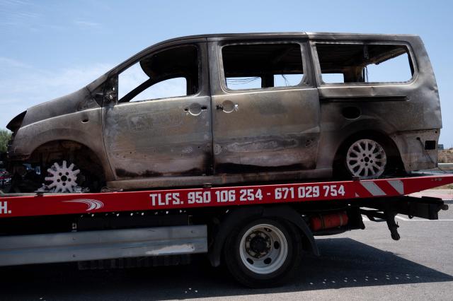 A picture taken on July 11, 2026 shows the burned-out car of one of the victims of a wildfire that killed 12, as it is transferred to an impound lot in Mojacar, near Los Gallardos, in Almeria Province. Firefighters aided by better weather on July 11 gained the upper hand on one of Spain's deadliest wildfires, that killed at least 12 people and burned about 6,600 hectares (16,300 acres) since July 9. (Photo by JORGE GUERRERO / AFP)