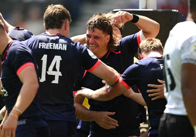 England's Benhard Janse van Rensburg (C) and England's wing Tommy Freeman (L) celebrate the team's third try during the Rugby Union Nations Championship match between Fiji and England at Hill Dickinson Stadium in Liverpool on July 11, 2026. (Photo by Oli SCARFF / AFP)
