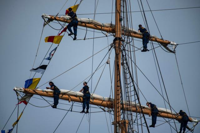 Crew on the USCGC Eagle climb the rigging during the Sail Boston Parade of Sail in Boston Harbor in Boston, Massachusetts on July 11, 2026. (Photo by Joseph Prezioso / AFP)