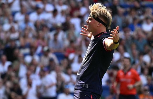 England's Henry Pollock celebrates after scoring the team's eleventh try, his hat-trick, during the Rugby Union Nations Championship match between Fiji and England at Hill Dickinson Stadium in Liverpool on July 11, 2026. (Photo by Oli SCARFF / AFP)