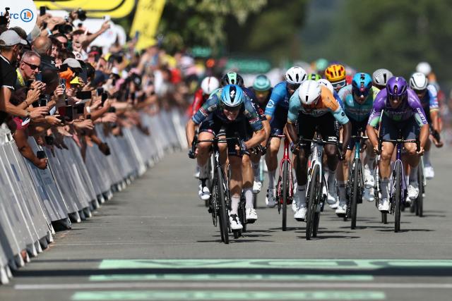 Soudal Quick-Step team's Belgian rider Tim Merlier (L) sprints to the finish line to win the 8th stage ahead of NSN Cycling Team's Eritrean rider Biniam Girmay (C) during the 113th edition of the Tour de France cycling race, 182 km between Périgueux and Bergerac in southwestern France, on July 11, 2026. (Photo by Anne-Christine POUJOULAT / AFP)