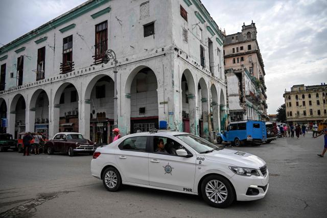 A police patrol car drives along a street in Havana on July 11, 2026. Cuba suffered its second nationwide blackout in five days on July 10 as twin energy and economic crises, compounded by a six-month US fuel blockade, caused the electricity grid to collapse. (Photo by YAMIL LAGE / AFP)