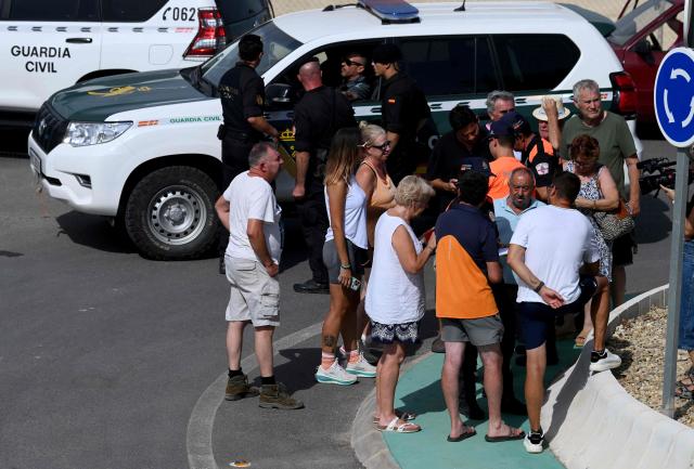 Residents wait for the authorisation of Spain's Guardia Civil officers before getting back to their house after a wildfire that killed at least 12 people, in Bedar, Almeria Province, on July 11, 2026. Firefighters aided by better weather on July 11 gained the upper hand on one of Spain's deadliest wildfires, that killed at least 12 people and burned about 6,600 hectares (16,300 acres) since July 9. (Photo by JOSE JORDAN / AFP)