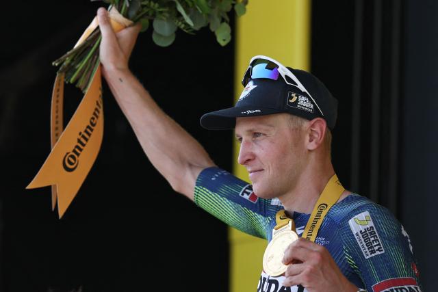 Soudal Quick-Step team's Belgian rider Tim Merlier celebrates on the podium after winning the 8th stage of the 113th edition of the Tour de France cycling race, 182 km between Périgueux and Bergerac in southwestern France, on July 11, 2026. (Photo by Anne-Christine POUJOULAT / AFP)