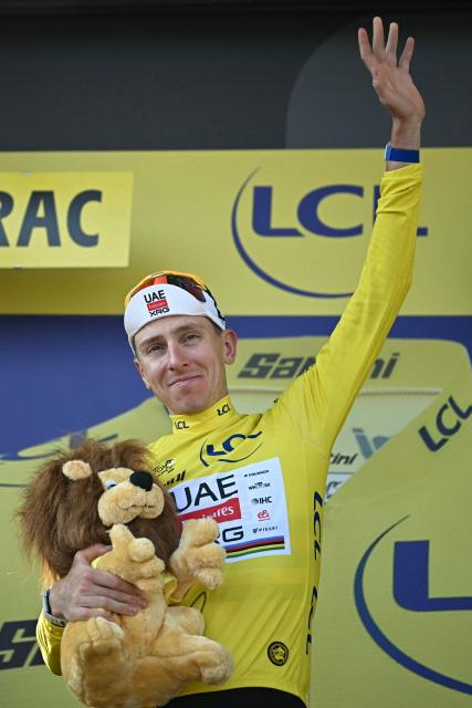UAE Team Emirates - XRG's Slovenian rider Tadej Pogacar celebrates on the podium with the overall leader's yellow jersey after the 8th stage of the 113th edition of the Tour de France cycling race, 182 km between Périgueux and Bergerac in southwestern France, on July 11, 2026. (Photo by Loic VENANCE / AFP)