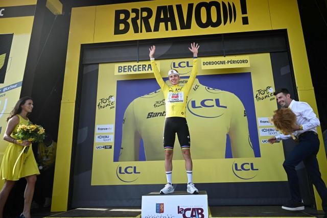 UAE Team Emirates - XRG's Slovenian rider Tadej Pogacar celebrates on the podium with the overall leader's yellow jersey after the 8th stage of the 113th edition of the Tour de France cycling race, 182 km between Périgueux and Bergerac in southwestern France, on July 11, 2026. (Photo by Loic VENANCE / AFP)