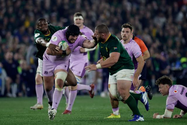 Scotland's prop Zander Fagerson is tackled by South Africa's prop Wilco Louw and South Africa's fullback Aphelele Fassi during the rugby Nations Championship match between South Africa and Scotland at Loftus Versfeld Stadium in Pretoria on July 11, 2026. (Photo by PHILL MAGAKOE / AFP)