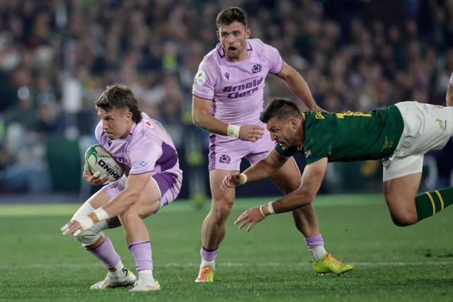 Scotland's fullback Kyle Rowe (L) is tackled by South Africa's fly-half Handre Pollard during the rugby Nations Championship match between South Africa and Scotland at Loftus Versfeld Stadium in Pretoria on July 11, 2026. (Photo by PHILL MAGAKOE / AFP)