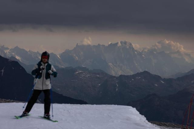 A skier sets off down the red run ‘Glacier’, in Tignes, south-eastern France, on July 11, 2026. Several ski runs and lifts on the Grande Motte Glacier, which is part of the Tignes ski area in the French Alps, allow skiing throughout the winter and into early summer.  The resort traditionally reopens selected alpine ski runs earlier than any other in France at the start of the autumn season. The glacier can be accessed via the Perce-Neige funicular, which connects Tignes Val Claret (at around 2,150 metres altitude) to the foot of the glacier (at 3,032 metres).From there, the Grande Motte cable car takes skiers and pedestrians to the 3,456-metre summit of the ski area, offering access to the glacier's highest slopes. (Photo by Alex MARTIN / AFP)