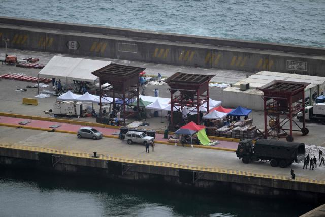 Military personnel and forensic specialists work at a makeshift morgue at the port of La Guaira, La Guaira state, Venezuela, on July 11, 2026, following the June 24 earthquakes. The death toll from the twin earthquakes that struck Venezuela on June 24 has risen to more than 4,300, National Assembly President Jorge Rodriguez said on July 11. (Photo by Juan BARRETO / AFP)