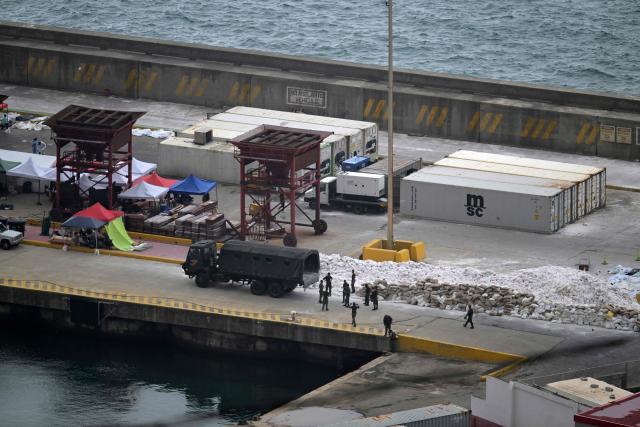Military personnel and forensic specialists work at a makeshift morgue at the port of La Guaira, La Guaira state, Venezuela, on July 11, 2026, following the June 24 earthquakes. The death toll from the twin earthquakes that struck Venezuela on June 24 has risen to more than 4,300, National Assembly President Jorge Rodriguez said on July 11. (Photo by Juan BARRETO / AFP)