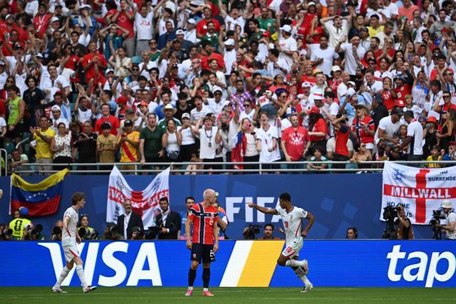England's midfielder #10 Jude Bellingham (R) celebrates scoring his team's first goal with forward #18 Anthony Gordon (L) during the 2026 World Cup football tournament quarter-final match between Norway and England at Miami Stadium in Miami Gardens on July 11, 2026.  (Photo by MAURO PIMENTEL / AFP)