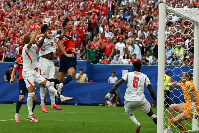 (L-R) England's forward #09 Harry Kane, England's defender #02 Ezri Konsa and Norway's midfielder #08 Sander Berge jump for a header as England's defender #06 Marc Guehi and England's goalkeeper #01 Jordan Pickford look on during the 2026 World Cup football tournament quarter-final match between Norway and England at Miami Stadium in Miami on July 11, 2026.  (Photo by ROBERTO SCHMIDT / AFP)