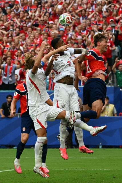 (L-R) England's forward #09 Harry Kane, England's defender #02 Ezri Konsa and Norway's midfielder #08 Sander Berge jump for a header during the 2026 World Cup football tournament quarter-final match between Norway and England at Miami Stadium in Miami on July 11, 2026.  (Photo by ROBERTO SCHMIDT / AFP)