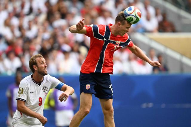Norway's defender #17 Torbjorn Heggem heads the ball past England's forward #09 Harry Kane during the 2026 World Cup football tournament quarter-final match between Norway and England at Miami Stadium in Miami Gardens on July 11, 2026.  (Photo by MAURO PIMENTEL / AFP)
