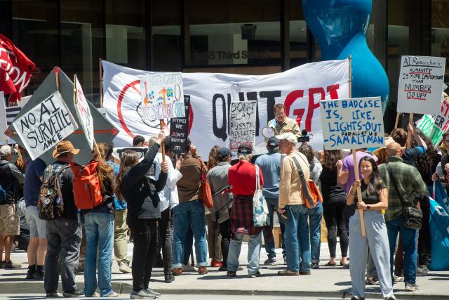 Dean Preston, attorney and former member of the San Francisco Board of Supervisors, speaks in front of the offices of Open AI during the "Stop the AI Race" protest march in San Francisco, California, on July 11, 2026. The protestors are making stops outside the offices of OpenAI, Anthropic and Google DeepMind. (Photo by Karl Mondon / AFP)