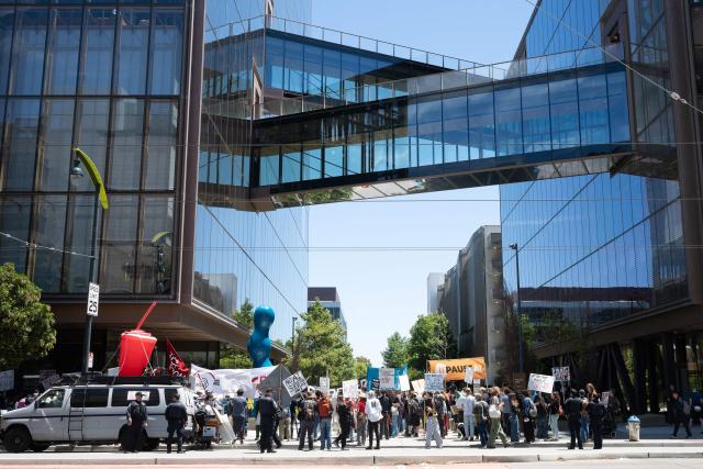 Protesters gather in front of the offices of Open AI as they participate in the "Stop the AI Race" protest march in San Francisco, California, on July 11, 2026. The protestors are making stops outside the offices of OpenAI, Anthropic and Google DeepMind. (Photo by Karl Mondon / AFP)