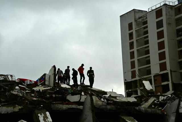 Rescue workers search through the rubble of a collapsed building in Caraballeda, La Guaira state, Venezuela, on July 11, 2026, following twin earthquakes that struck the region. The death toll from the twin earthquakes that struck Venezuela on June 24 has risen to more than 4,300, National Assembly President Jorge Rodriguez said on July 11. (Photo by MARTIN BERNETTI / AFP)